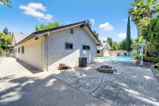 3547 W Locust Ave, Fresno, CA 93711 - back of property with a fire pit, stucco siding, a patio, and a fenced backyard