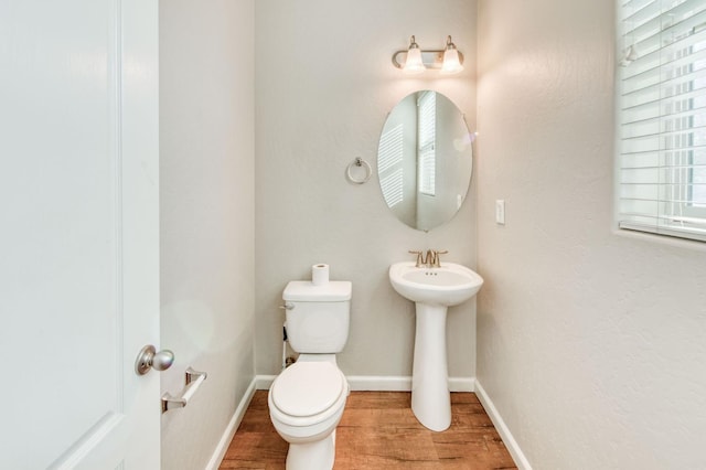 5516 N Sebastian Ln, Fresno, CA 93722 - bathroom with wood finished floors and toilet