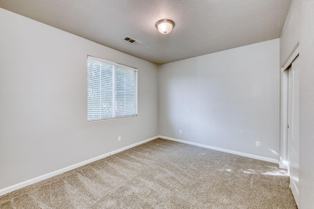 5516 N Sebastian Ln, Fresno, CA 93722 - spare room featuring carpet flooring and a textured ceiling