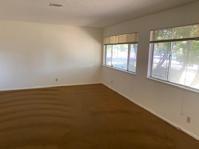4902 E Townsend Ave, Fresno, CA 93727 - spare room with carpet and a textured ceiling