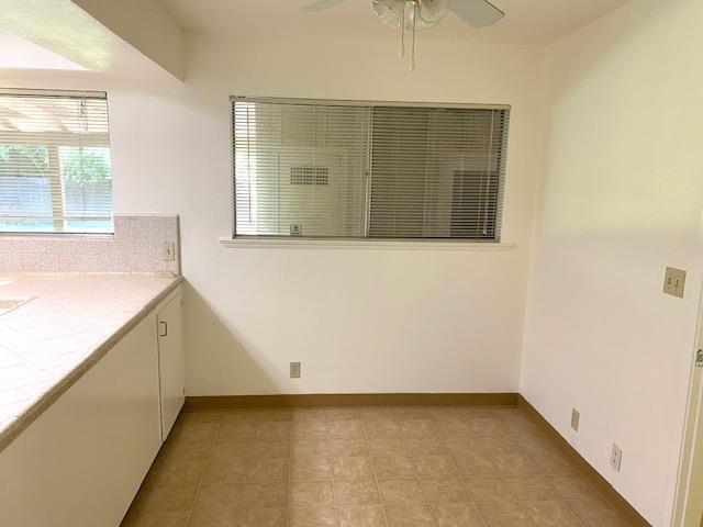 4902 E Townsend Ave, Fresno, CA 93727 - unfurnished dining area with ceiling fan and light tile patterned floors