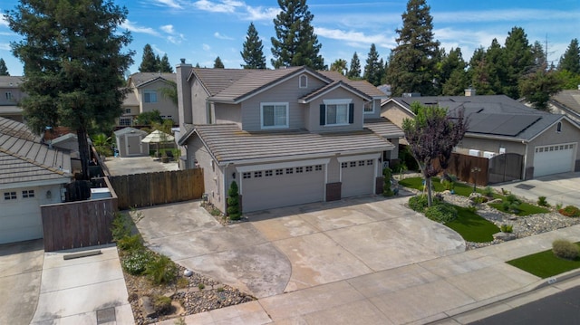 2518 Keats Ave, Fresno, CA 93611 - traditional home with a tile roof, a chimney, concrete driveway, a garage, and a residential view