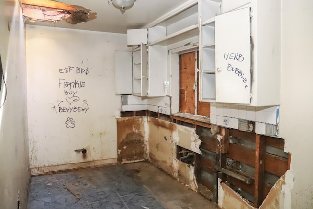 2413 S Sierra Vista Ave, Fresno, CA 93725 - kitchen with concrete floors, white cabinets, and open shelves