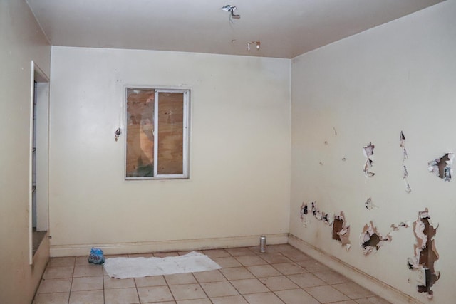 2413 S Sierra Vista Ave, Fresno, CA 93725 - spare room with light tile patterned floors and baseboards