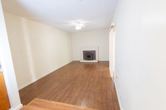 2739 Fine Ave, Clovis, CA 93612 - unfurnished living room with hardwood / wood-style floors, a brick fireplace, and a ceiling fan