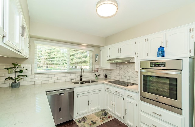 11851 Waverly Rd, Madera, CA 93636 - kitchen featuring appliances with stainless steel finishes, under cabinet range hood, white cabinetry, and decorative backsplash