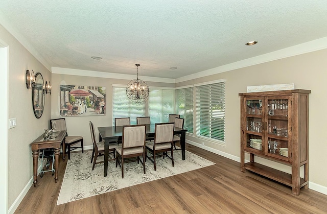 5383 N Briarwood Ave, Fresno, CA 93711 - dining room with wood finished floors, a textured ceiling, a chandelier, healthy amount of natural light, and ornamental molding