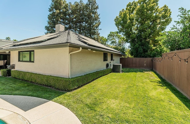 5383 N Briarwood Ave, Fresno, CA 93711 - view of side of property featuring stucco siding, a fenced backyard, roof mounted solar panels, and a chimney