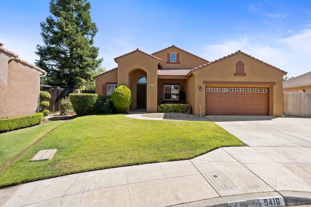 9416 N Jade Ave, Fresno, CA 93720 - mediterranean / spanish-style house featuring a tiled roof, stucco siding, concrete driveway, and an attached garage