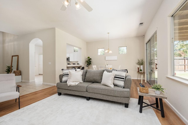 9416 N Jade Ave, Fresno, CA 93720 - living room with light wood finished floors, arched walkways, and ceiling fan