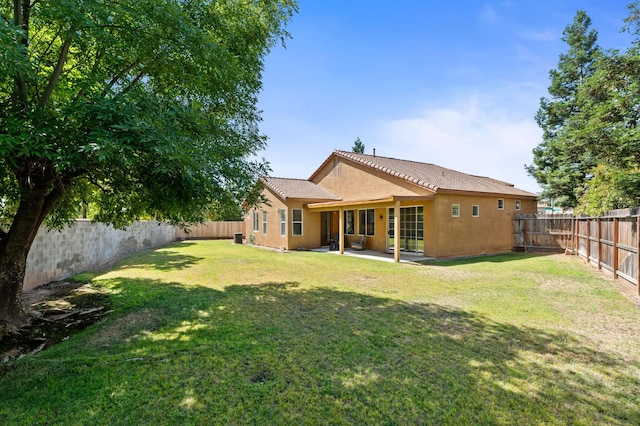 9416 N Jade Ave, Fresno, CA 93720 - rear view of property with a fenced backyard, stucco siding, a patio, and a tile roof