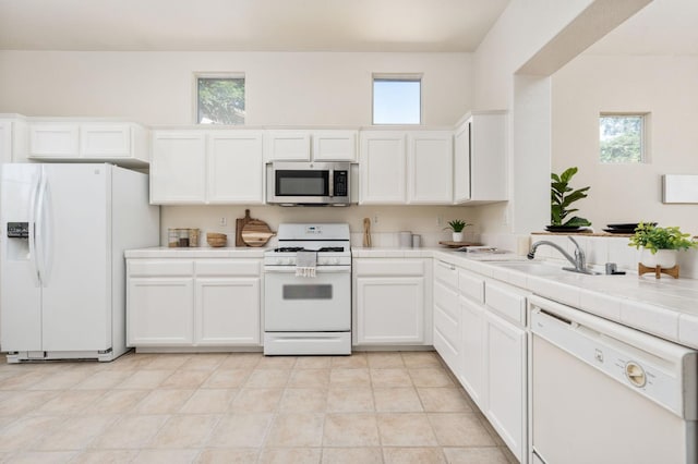 9416 N Jade Ave, Fresno, CA 93720 - kitchen featuring white appliances, tile counters, and white cabinetry