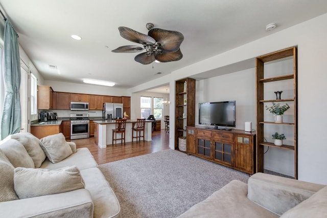 7345 E Giavanna Ave, Fresno, CA 93737 - living room featuring ceiling fan, light wood-type flooring, and recessed lighting
