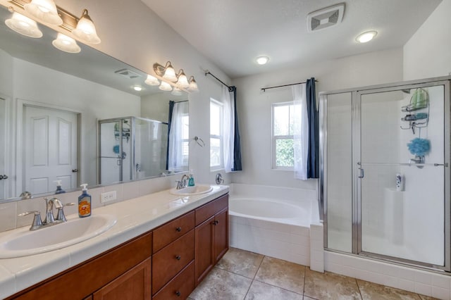 7345 E Giavanna Ave, Fresno, CA 93737 - bathroom featuring a shower stall, double vanity, a bath, and tile patterned floors