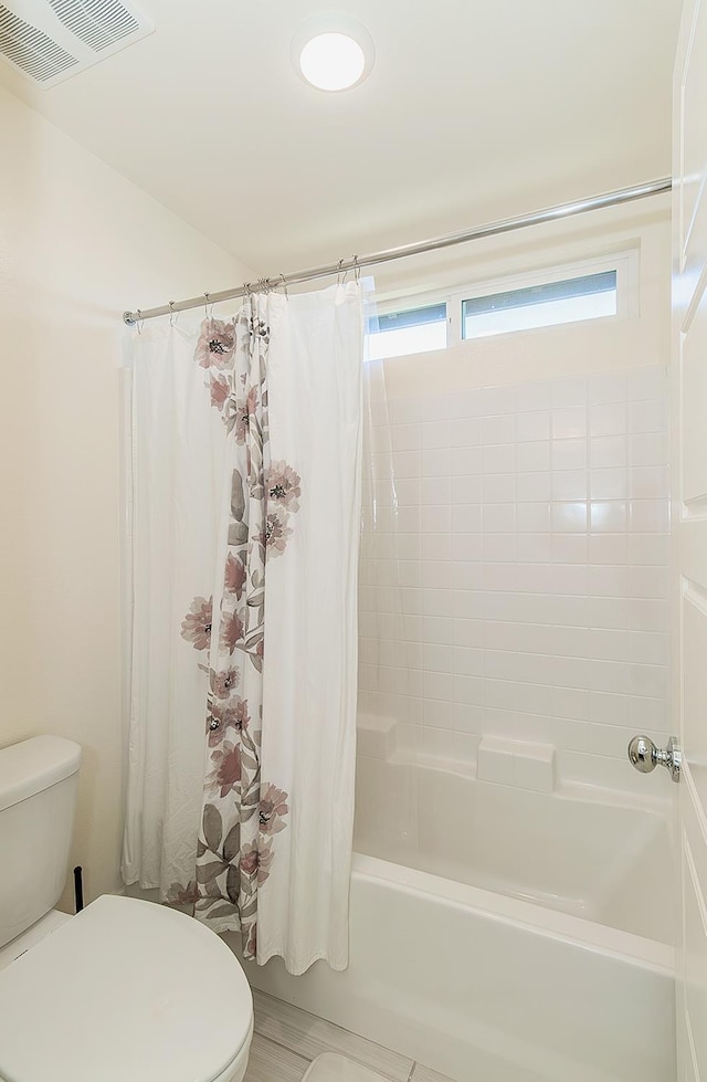 463 Mesa Dr S, Madera, CA 93636 - bathroom featuring toilet and shower / bath combination with curtain