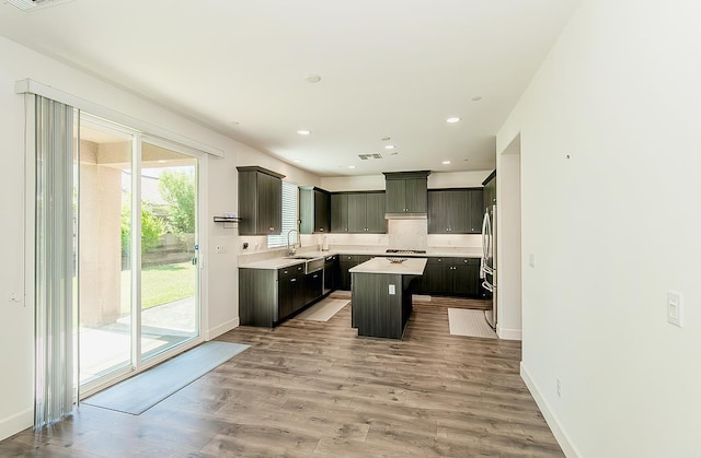 463 Mesa Dr S, Madera, CA 93636 - kitchen featuring a center island, appliances with stainless steel finishes, light countertops, light wood-type flooring, and recessed lighting