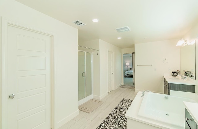 463 Mesa Dr S, Madera, CA 93636 - bathroom with connected bathroom, vanity, a stall shower, recessed lighting, and a bath