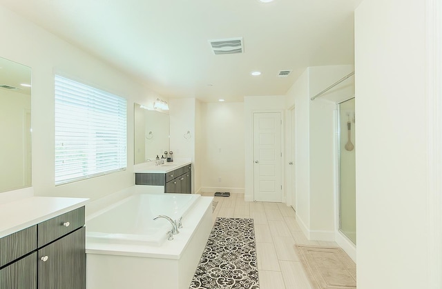 463 Mesa Dr S, Madera, CA 93636 - bathroom featuring vanity, a garden tub, recessed lighting, a stall shower, and tile patterned flooring