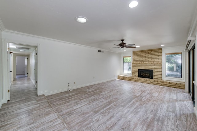6328 N Benedict Ave, Fresno, CA 93711 - unfurnished living room with ceiling fan, crown molding, light wood-type flooring, recessed lighting, and a brick fireplace