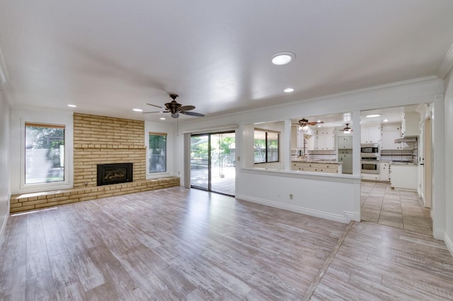6328 N Benedict Ave, Fresno, CA 93711 - unfurnished living room with ceiling fan, crown molding, healthy amount of natural light, a fireplace, and recessed lighting