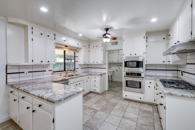 6328 N Benedict Ave, Fresno, CA 93711 - kitchen featuring appliances with stainless steel finishes, a peninsula, tasteful backsplash, ceiling fan, and white cabinets