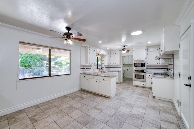 6328 N Benedict Ave, Fresno, CA 93711 - kitchen with appliances with stainless steel finishes, a ceiling fan, a peninsula, tasteful backsplash, and white cabinetry