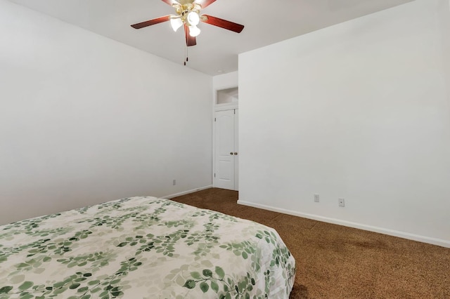 5613 W Bluff Ave, Fresno, CA 93722 - bedroom featuring dark carpet and ceiling fan