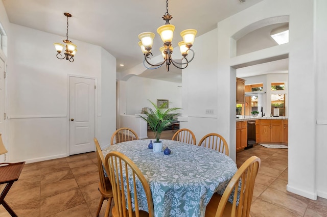 5613 W Bluff Ave, Fresno, CA 93722 - dining room featuring a chandelier and light tile patterned flooring