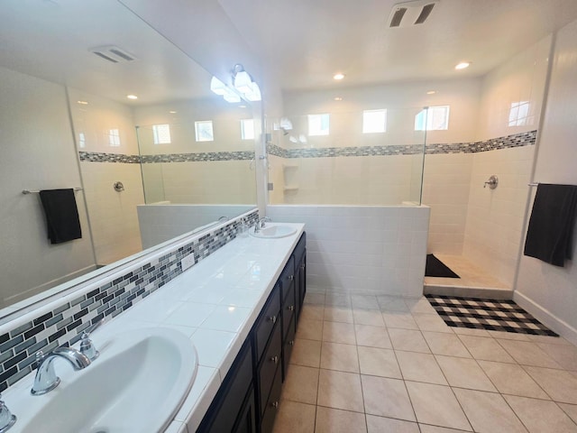 117 Emperor Way, Dinuba, CA 93618 - bathroom featuring tile patterned flooring, double vanity, walk in shower, healthy amount of natural light, and recessed lighting