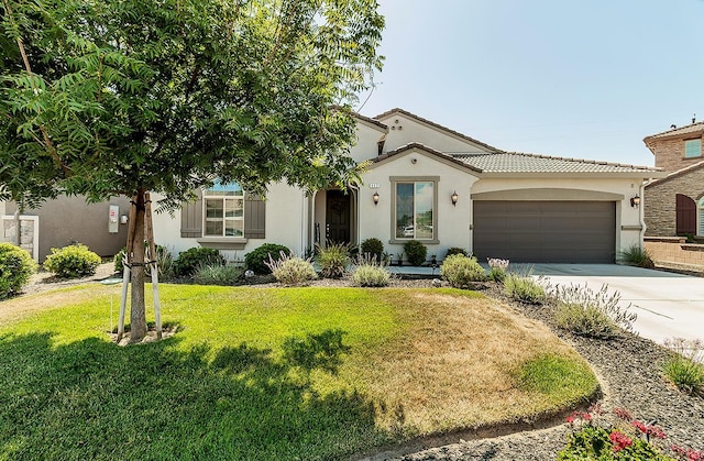 117 Emperor Way, Dinuba, CA 93618 - mediterranean / spanish house with stucco siding, concrete driveway, a garage, a front yard, and a tile roof