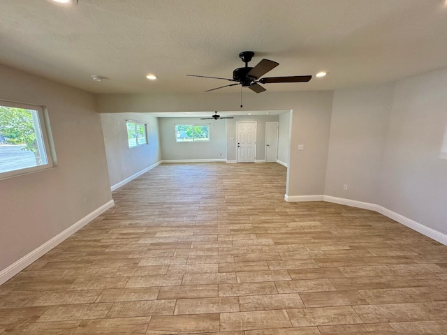195 Hoover St, Coalinga, CA 93210 - unfurnished room with a ceiling fan, light wood-style flooring, recessed lighting, and a textured ceiling