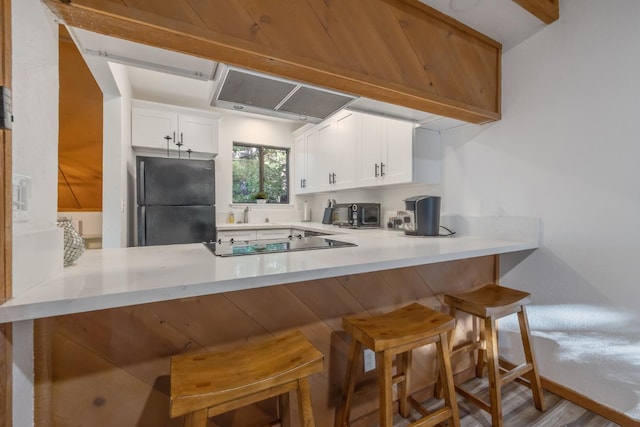 40607 Mill Run Ln Unit 72, Shaver Lake, CA 93664 - kitchen featuring black appliances, a peninsula, extractor fan, and light countertops