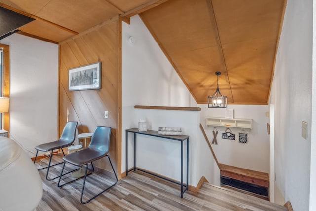 40607 Mill Run Ln Unit 72, Shaver Lake, CA 93664 - sitting room with wood finished floors, wooden walls, a chandelier, and an upstairs landing