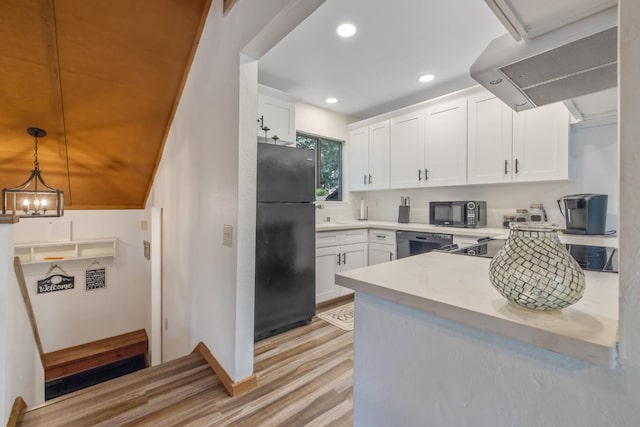 40607 Mill Run Ln Unit 72, Shaver Lake, CA 93664 - kitchen featuring black appliances, exhaust hood, light wood-type flooring, light countertops, and white cabinets