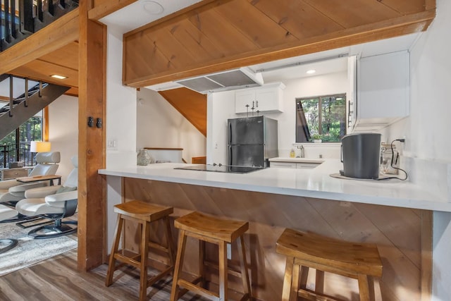 40607 Mill Run Ln Unit 72, Shaver Lake, CA 93664 - kitchen featuring black appliances, wood finished floors, plenty of natural light, and white cabinets