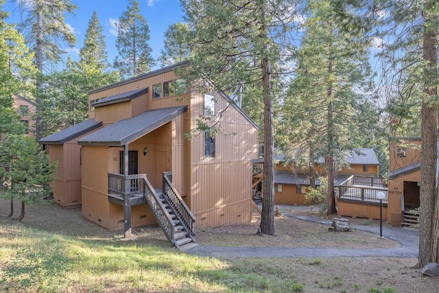 40607 Mill Run Ln Unit 72, Shaver Lake, CA 93664 - rear view of property featuring stairs, a wooden deck, a metal roof, and crawl space