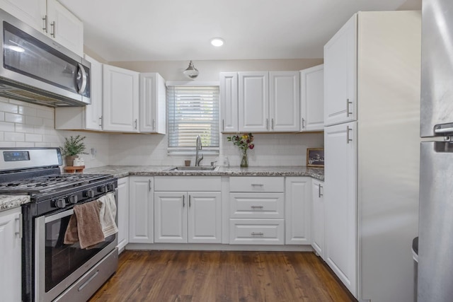723 N Lourae Ave, Reedley, CA 93654 - kitchen featuring stainless steel appliances, white cabinetry, decorative backsplash, light stone counters, and recessed lighting