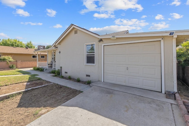 723 N Lourae Ave, Reedley, CA 93654 - view of front of property with crawl space, concrete driveway, an attached garage, and stucco siding
