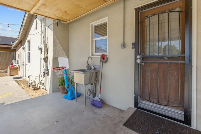 723 N Lourae Ave, Reedley, CA 93654 - doorway to property featuring stucco siding and a sink