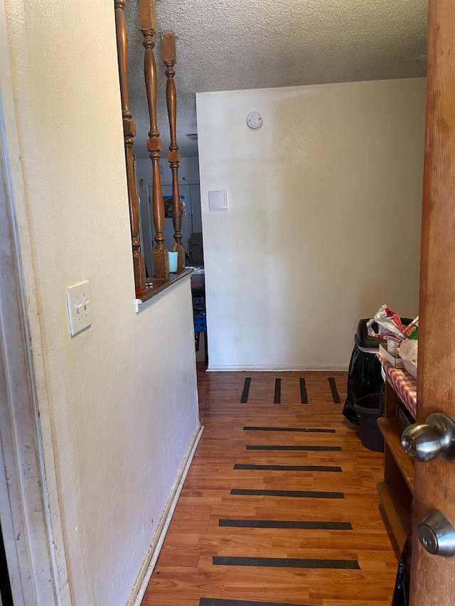 2327 S Martin L King Jr Blvd, Fresno, CA 93706 - hallway featuring wood finished floors and a textured ceiling