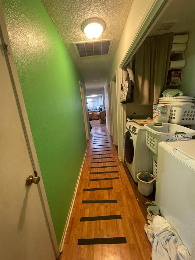 2327 S Martin L King Jr Blvd, Fresno, CA 93706 - laundry area featuring washer and clothes dryer, wood finished floors, and a textured ceiling
