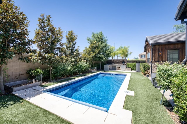 4240 Rall Ave, Clovis, CA 93619 - view of pool featuring a fenced backyard, an outdoor kitchen, a garden, and a patio area