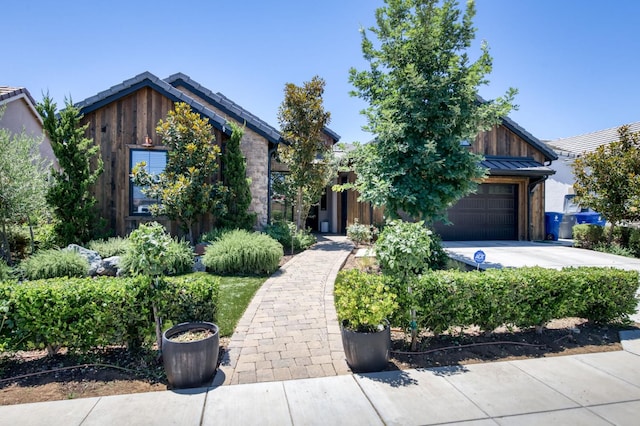 4240 Rall Ave, Clovis, CA 93619 - view of front of house with an attached garage, board and batten siding, and concrete driveway