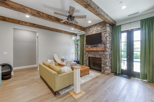 4240 Rall Ave, Clovis, CA 93619 - living area with light wood-style floors, beamed ceiling, french doors, a stone fireplace, and ceiling fan