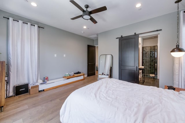 4240 Rall Ave, Clovis, CA 93619 - bedroom featuring a barn door, recessed lighting, wood finished floors, a ceiling fan, and connected bathroom