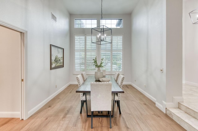 7334 N Geraldine Ave, Fresno, CA 93711 - dining area featuring a chandelier and light wood-style flooring