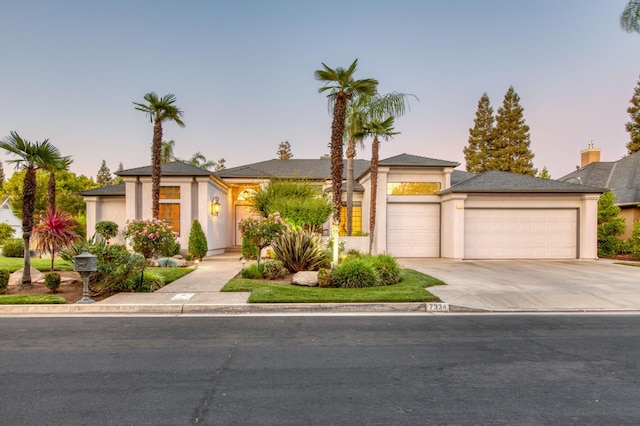 7334 N Geraldine Ave, Fresno, CA 93711 - view of front of property featuring a garage, concrete driveway, and stucco siding