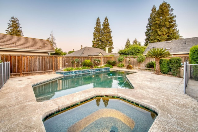 7334 N Geraldine Ave, Fresno, CA 93711 - view of swimming pool with an in-ground hot tub, a fenced backyard, and a patio area