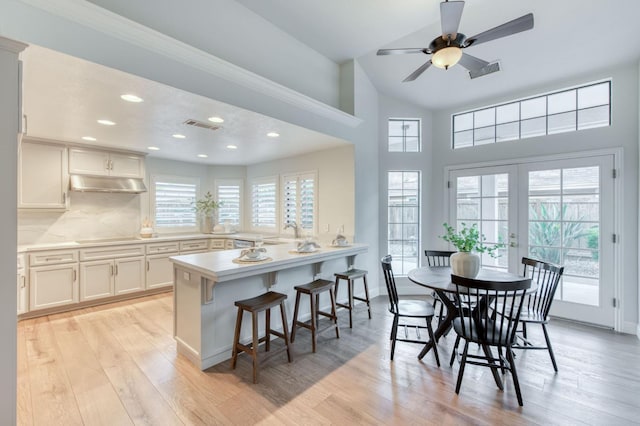 7334 N Geraldine Ave, Fresno, CA 93711 - dining area featuring light wood-style flooring, recessed lighting, a ceiling fan, french doors, and high vaulted ceiling