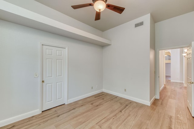 7334 N Geraldine Ave, Fresno, CA 93711 - empty room with a ceiling fan, light wood-style floors, and arched walkways